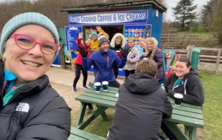 Sarah & Gareth post parkrun with friends grabbing a coffee from the outdoor kiosk